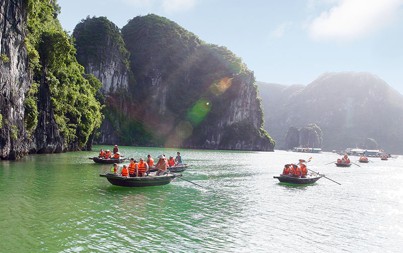 There are multiple pleasure boats at the shore heading to Ha Long Bay.