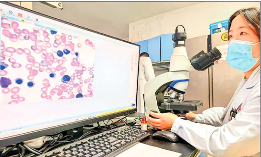 An examiner checks the results made by an artificial intelligence (AI) model for blood cell testing in a laboratory at Xinqiao Hospital under the Army Medical University in southwest China’s Chongqing, 14 February 2023. PHOTO: PIX FOR VISUAL PURPOSE/ XINQIAO HOSPITAL/HANDOUT VIA XINHUA 