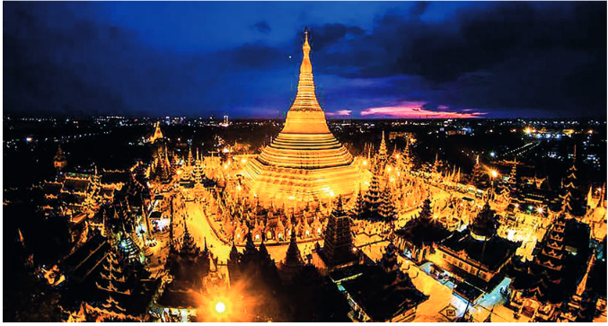 Drone aerial view of the illuminated Shwedagon Pagoda at night