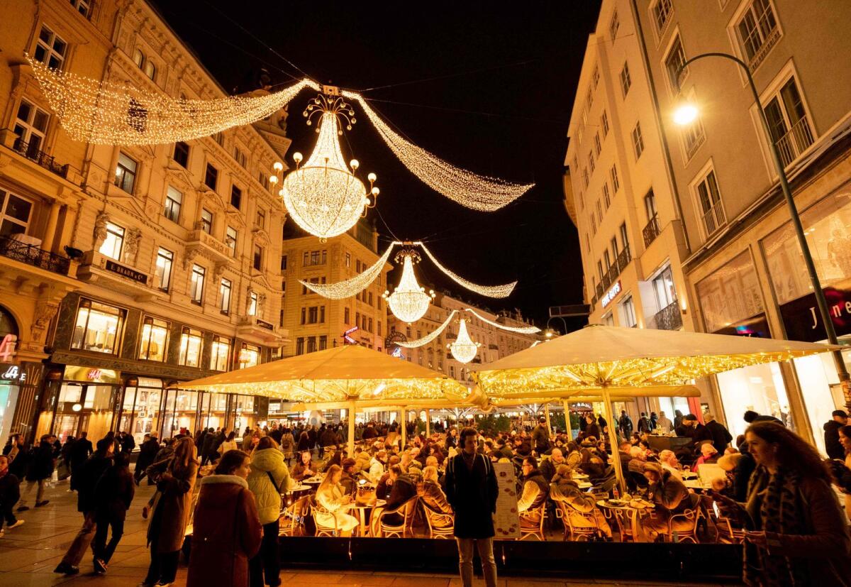 People are seen with Christmas lights in the city centre of Vienna, Austria on 15 November 2024. PHOTO: JOE KLAMAR / AFP