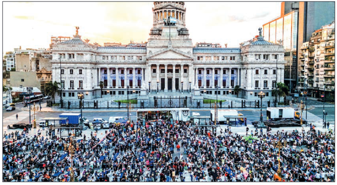 Aerial view showing volunteers and homeless people taking part in a Christmas solidarity dinner called ‘No Families Without Christmas’ in front of the National Congress in Buenos Aires on 24 December 2024. PHOTO: TOMAS CUESTA / AFP