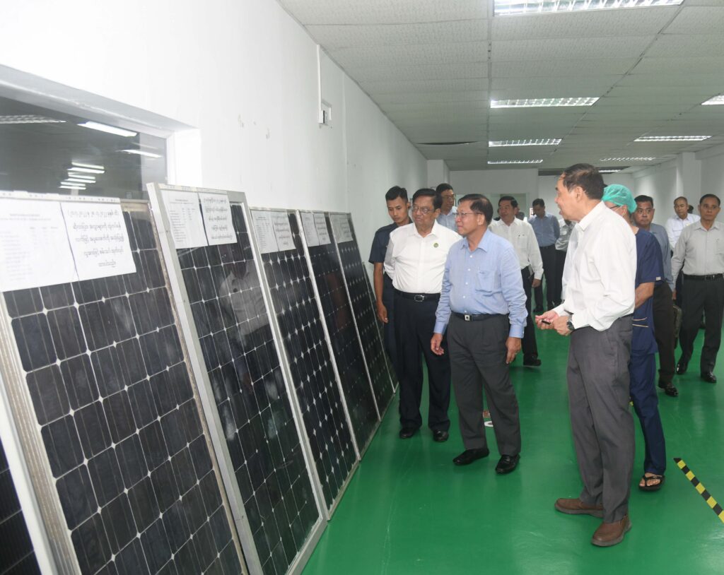 State Administration Council Chairman Prime Minister Senior General Min Aung Hlaing observes solar panels produced at the Solar Panel Factory of Shwe Katha Company Limited under the Electronic Accessories and Electric Motor Workshop of the No 2 Heavy Industries Enterprise in Yangon Region
