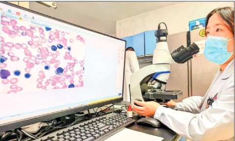 An examiner checks the results made by an artificial intelligence (AI) model for blood cell testing in a laboratory at Xinqiao Hospital under the Army Medical University in southwest China’s Chongqing, 14 February 2023. PHOTO: PIX FOR VISUAL PURPOSE/ XINQIAO HOSPITAL/HANDOUT VIA XINHUA