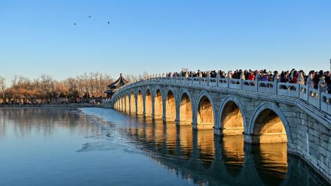 This photo taken on 17 December 2024 shows the illuminated arches of the 17-Arch Bridge at sunset in the Summer Palace in Beijing. PHOTO: XINHUA