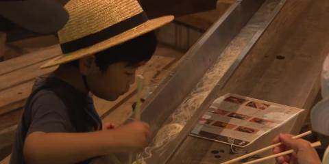 Visitors to Japanese valley cool down with water-streamed noodles