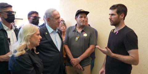 Netanyahu vows at stricken kibbutz to bring hostages home