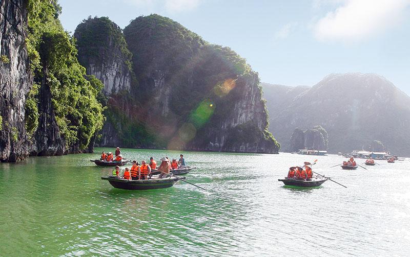 There are multiple pleasure boats at the shore heading to Ha Long Bay.